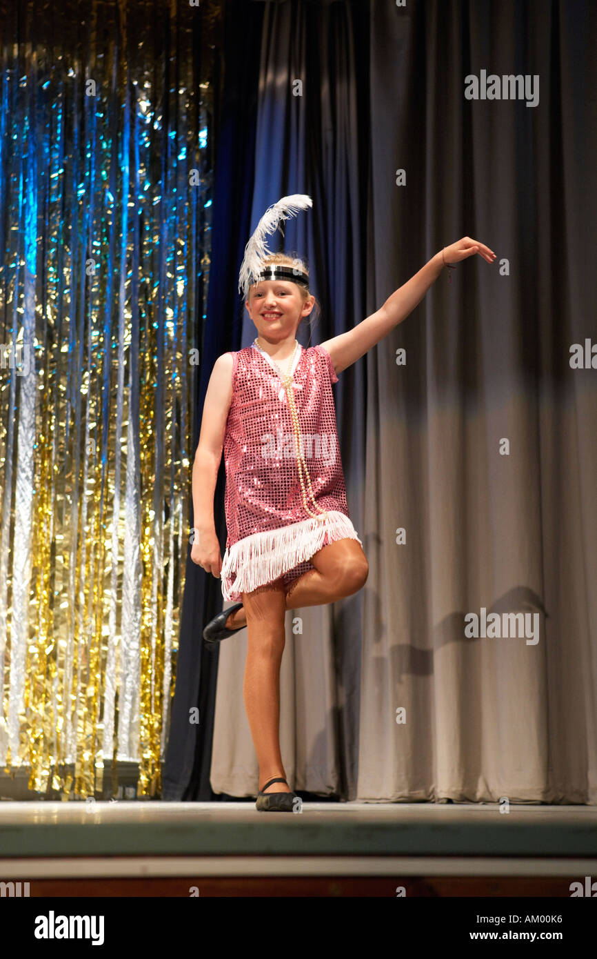 Nine year old girl on stage perfoming a dance show Stock Photo