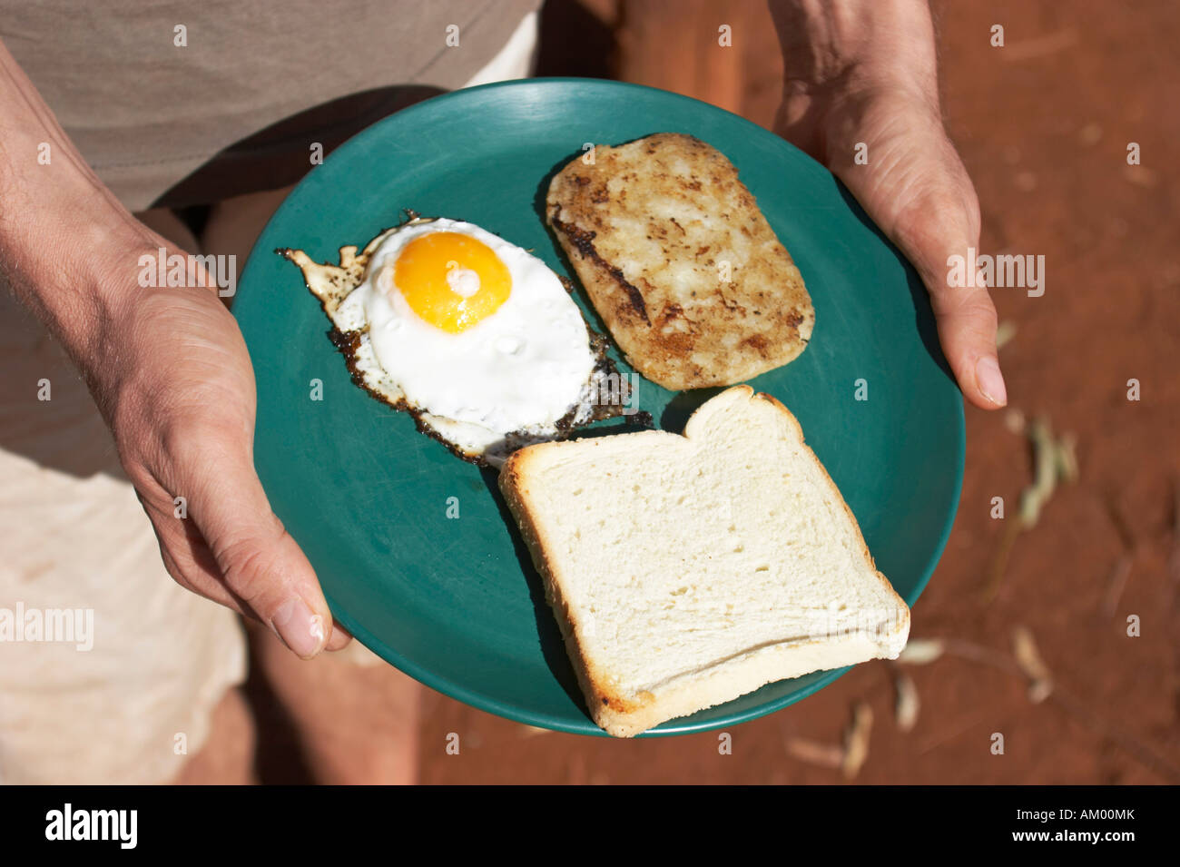 Fried egg, lpotato pancakes and bright toast Stock Photo