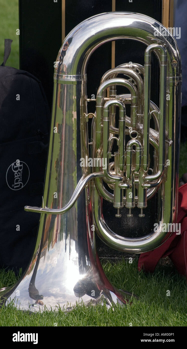 Tuba rested on the grass at Ely bandstand, mouthpiece removed Stock Photo