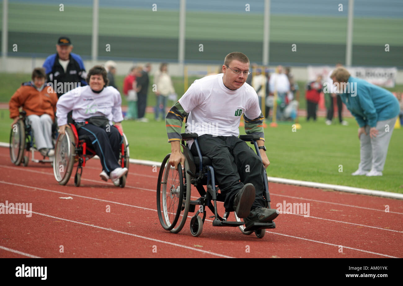 Handicapped man racing with a wheelchair Stock Photo