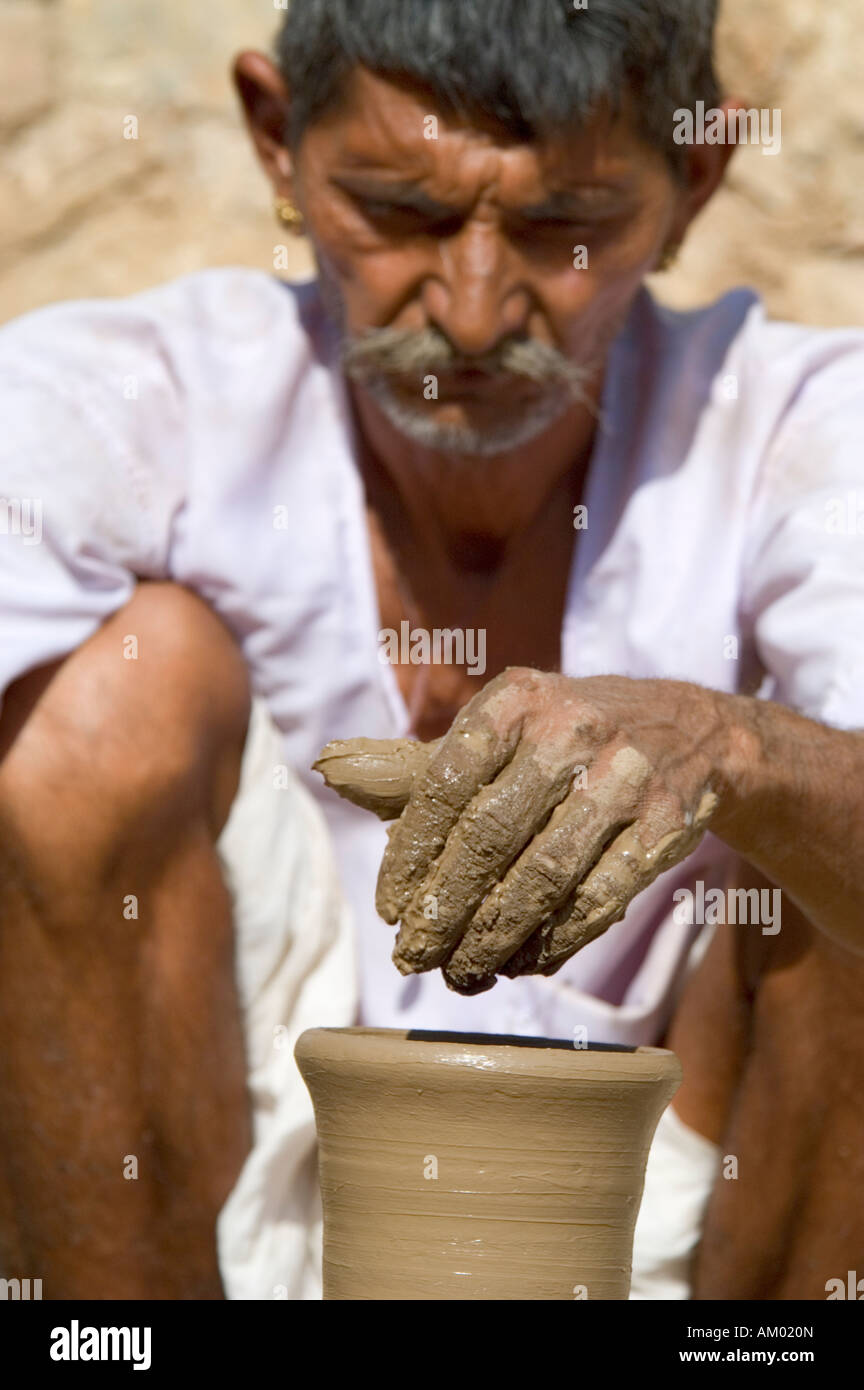 Indra, a potter from the village of Nimaj, creates a water jug on his hand wheel in Rajasthan, India. - Stock Image