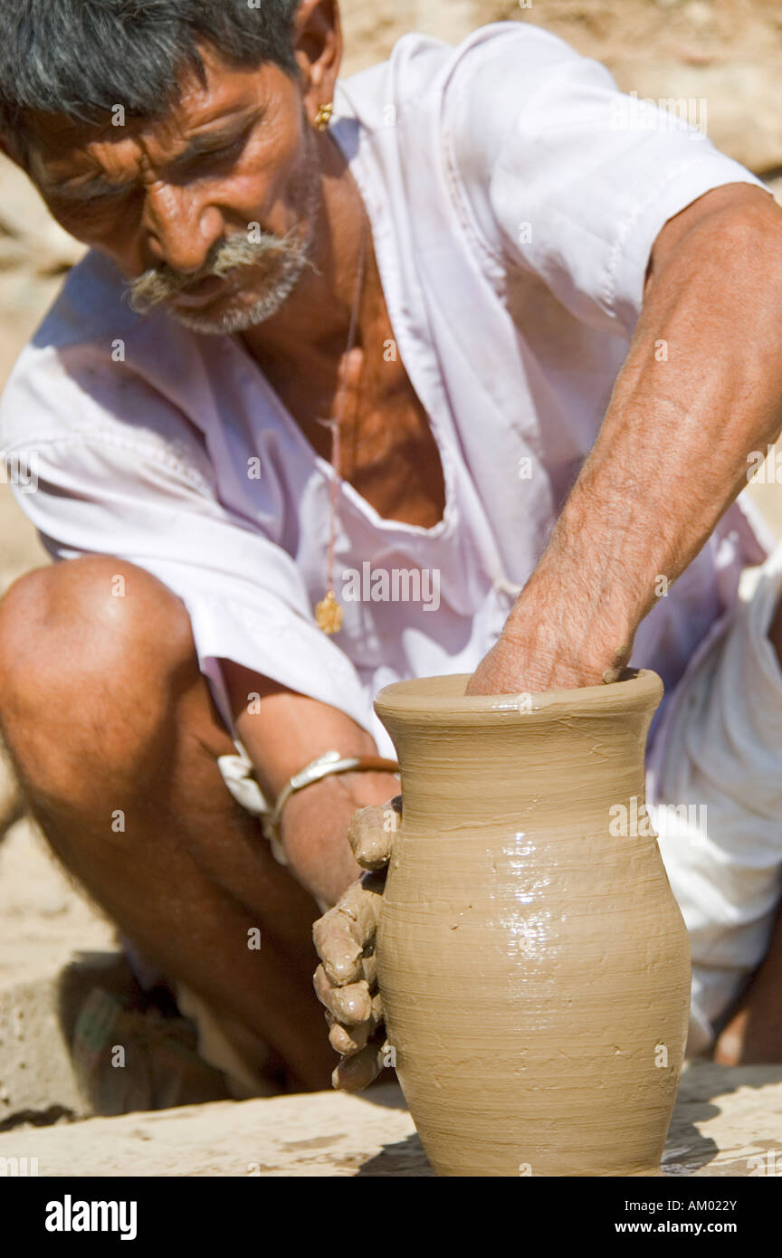 Indra, a potter from the village of Nimaj, creates a water jug on his hand wheel in Rajasthan, India. - Stock Image