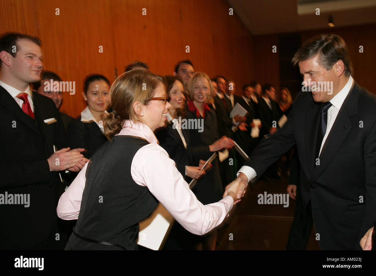 Dr. Josef Ackermann, chairman of the board of management from the Deutsche Bank AG, shaking hands with economy students Stock Photo