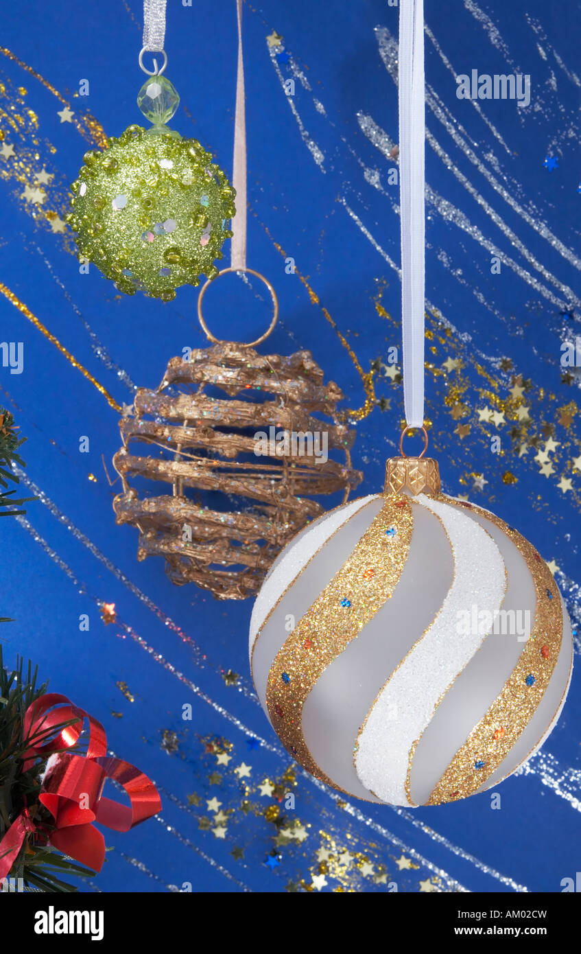 Festive Christmas composition with various hanging holiday balls on blue decorative winter background with sparkles and stars Stock Photo