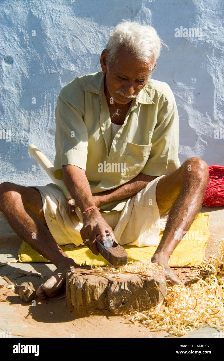 A Rajasthani carpenter planes a cane outside his home in the village of Nimaj, Rajasthan, India. - Stock Image