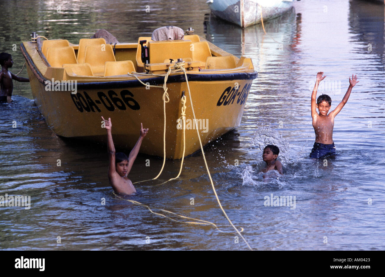 Indian boys swimming in the Baga river in Goa in the South of India Stock Photo