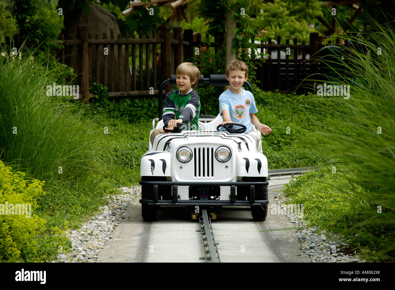 Two children are driving with a little car in theme park Legoland, Guenzburg, Germany Stock Photo
