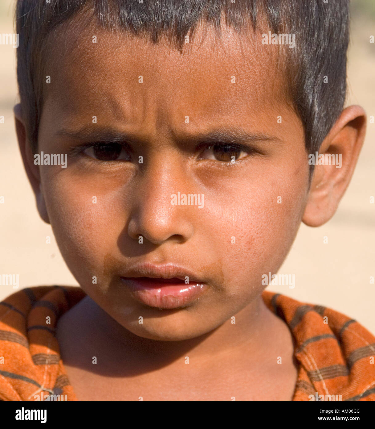 A young boy outside his home in the dunes of the Great Thar Desert near Manvar, Rajasthan, India. - Stock Image