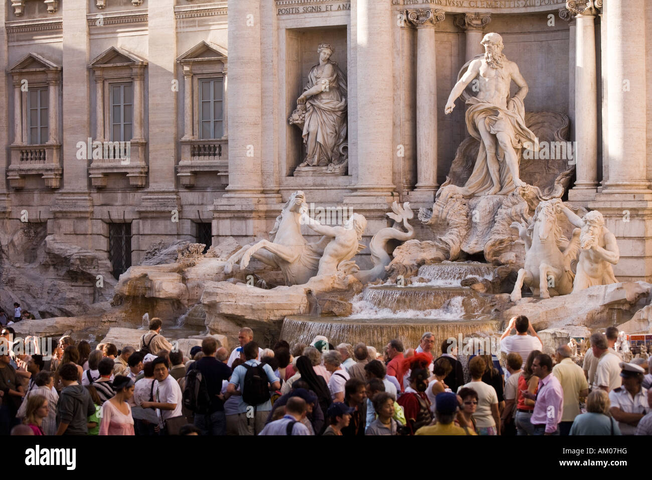 Tourists bustling around the Trevi Fountain Stock Photo