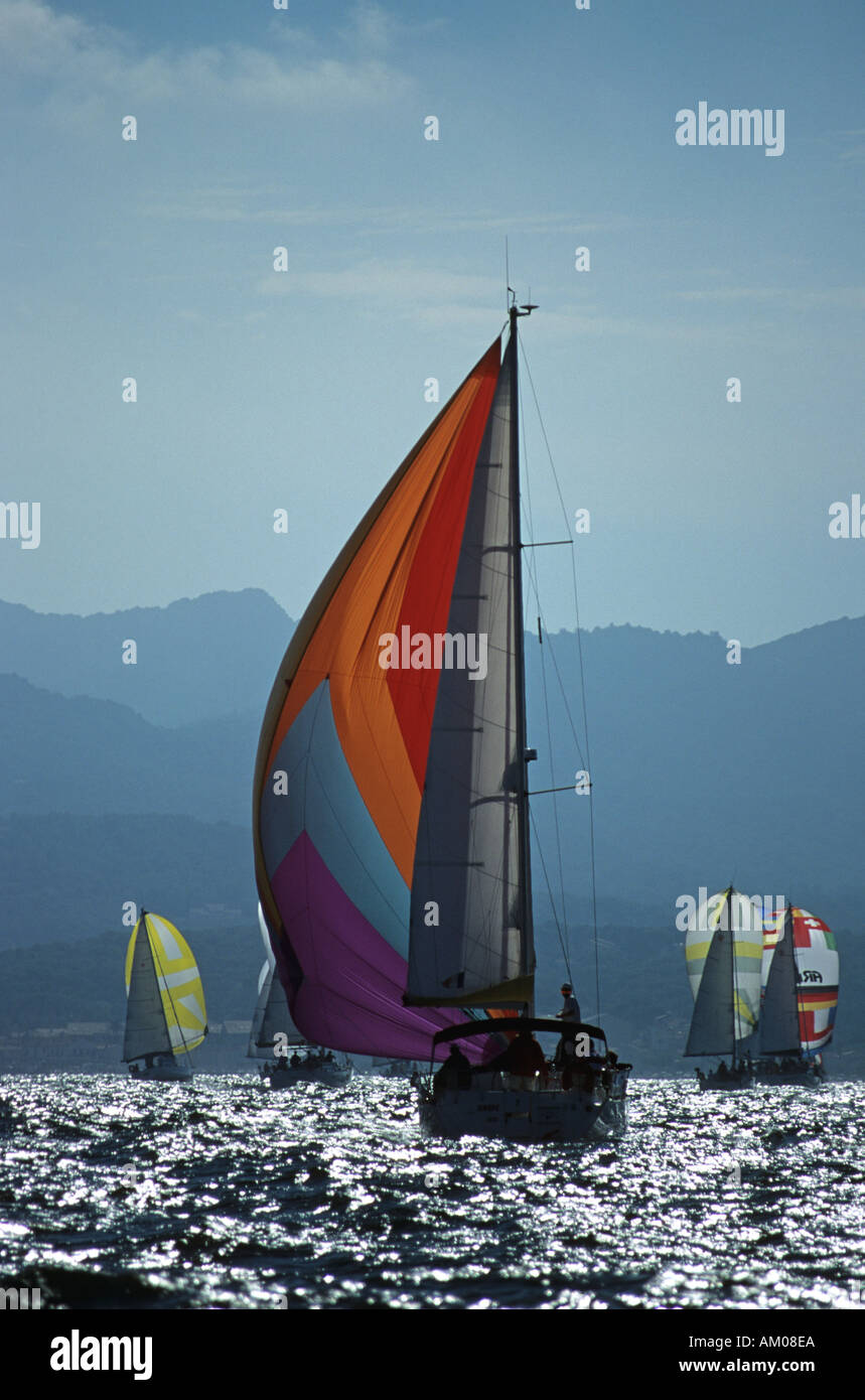 France Europe Yacht with unfold spinnaker and mountains Stock Photo