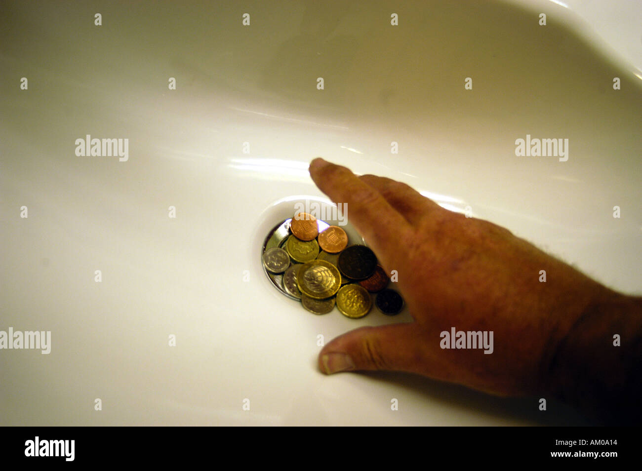 Throwing money down the drain hires stock photography and images Alamy