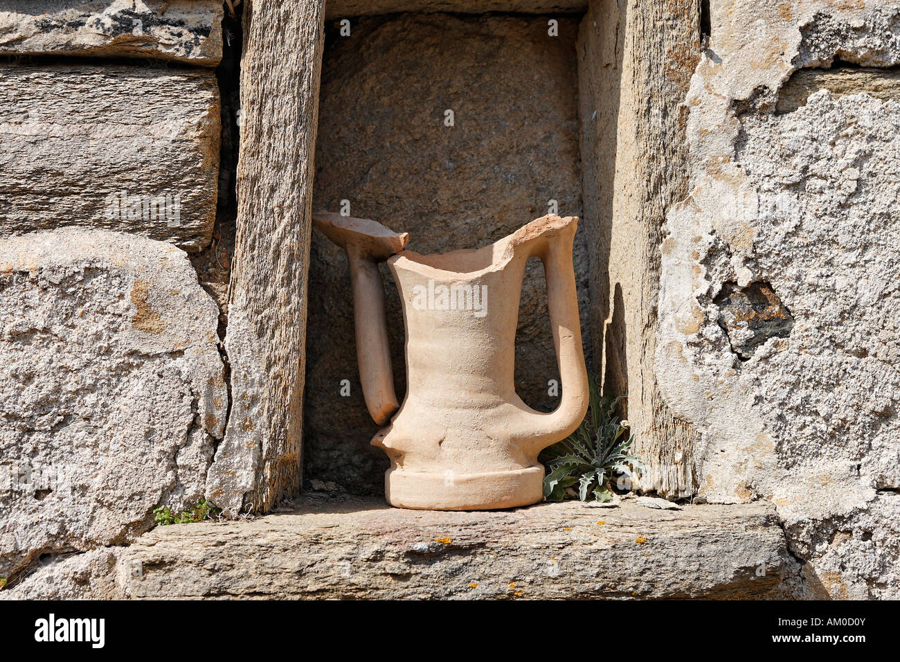 Jar made of clay on wall near so-called lake-house, Delos, Greece Stock Photo