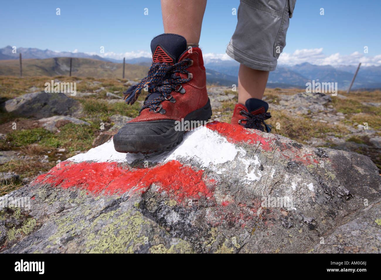 Foot of a child on a stone with red and white marking Stock Photo