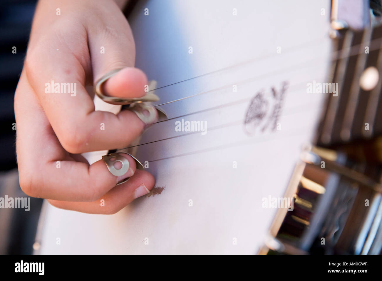 ILLINOIS Galena Close view of hands of teenage boy playing the banjo picks on fingers plucking strings Stock Photo