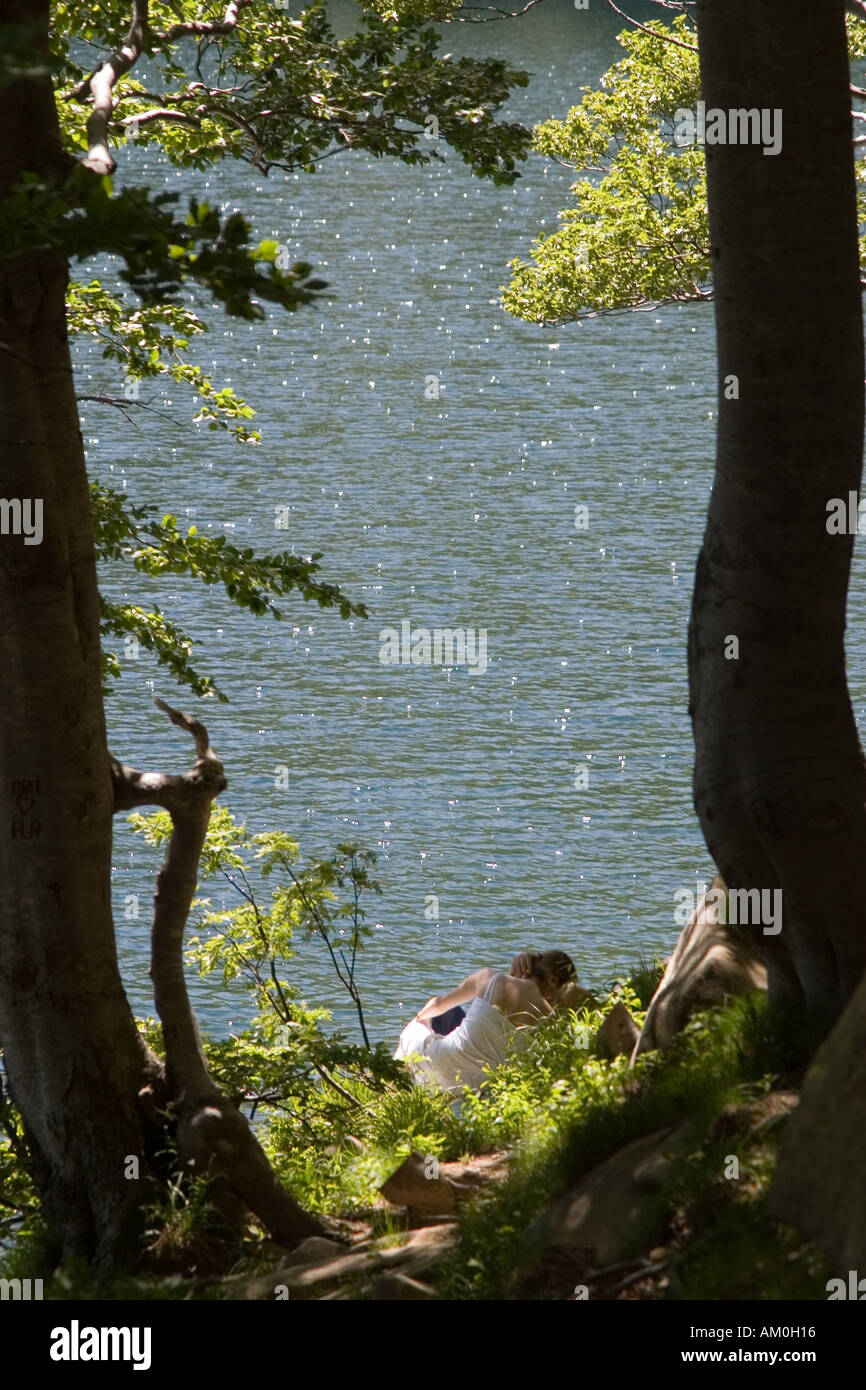 lovers kissing by the lake Stock Photo