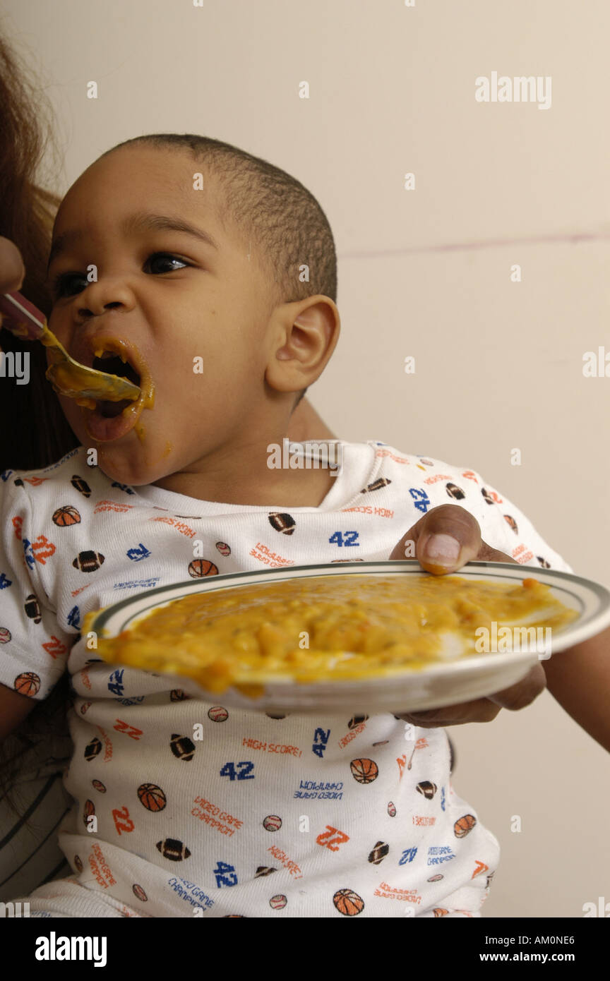 Baby spoon eat african hi-res stock photography and images - Alamy