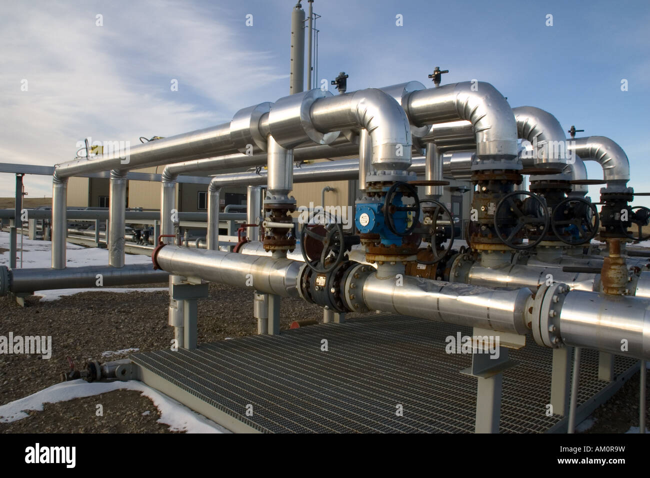 Gas pipeline riser with compressor and dehy station in the background