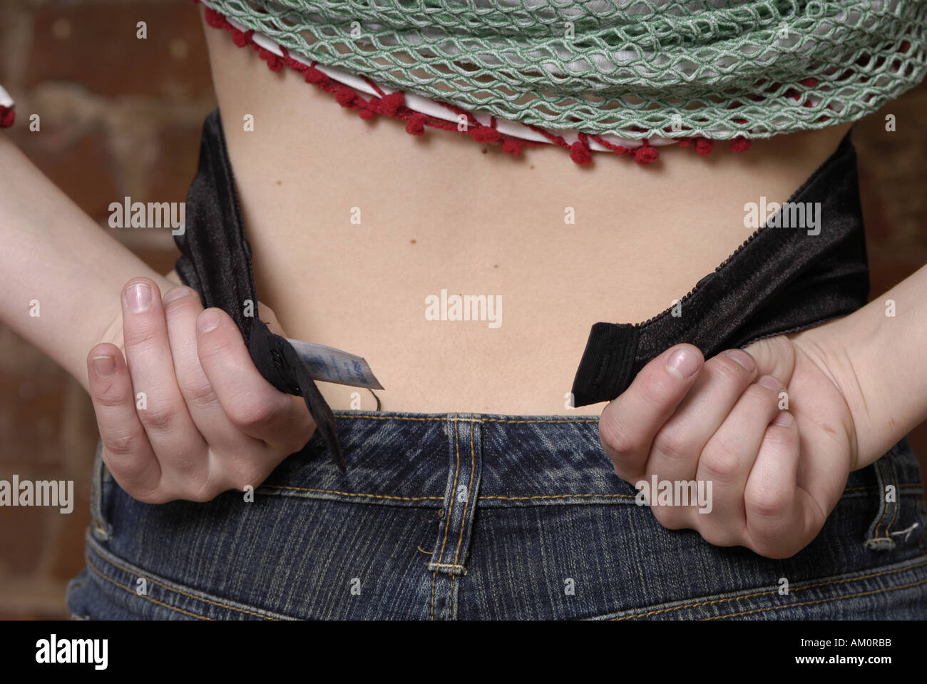 Jeans midriff waist weight loss diet fasten fastener buttoned Stock Photo