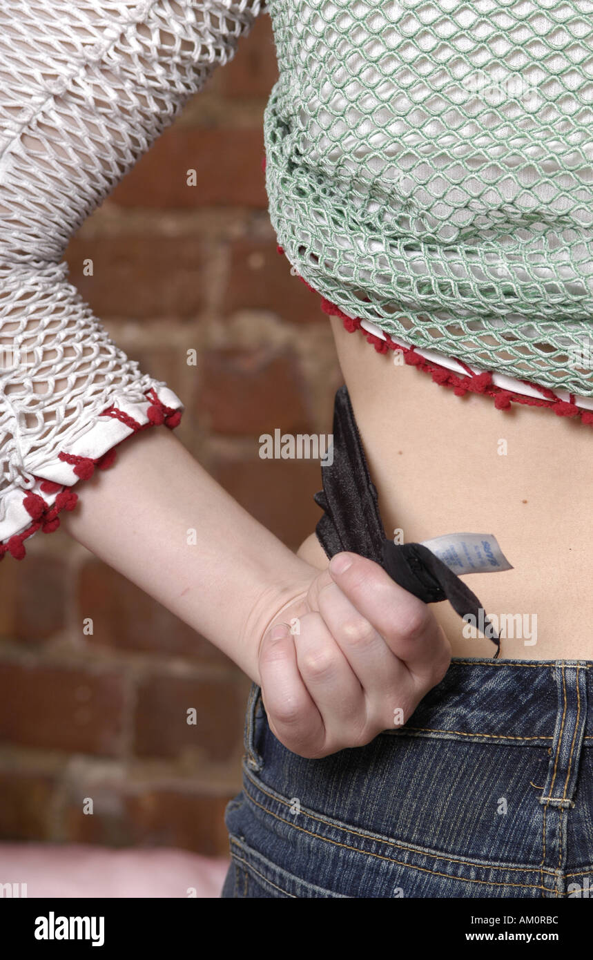 Jeans midriff waist weight loss diet fasten fastener buttoned Stock Photo