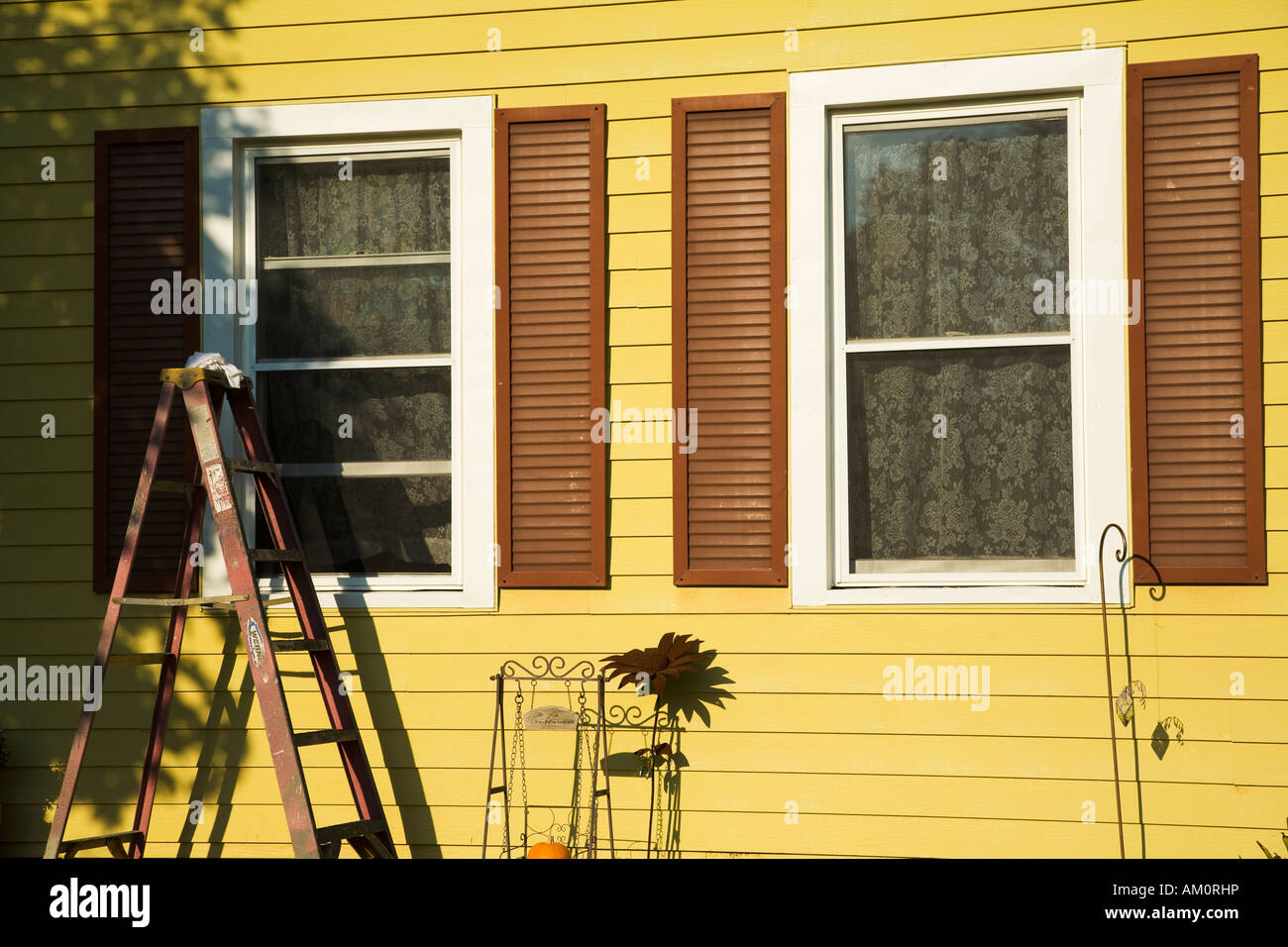 ILLINOIS Galena Front of middle class house in small town siding ladder by window brown shutters