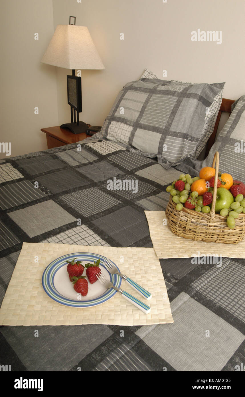 fruit basket breakfast in bed breakfast complimentary welcome room service gift  basket hotel hotel room suite Stock Photo - Alamy