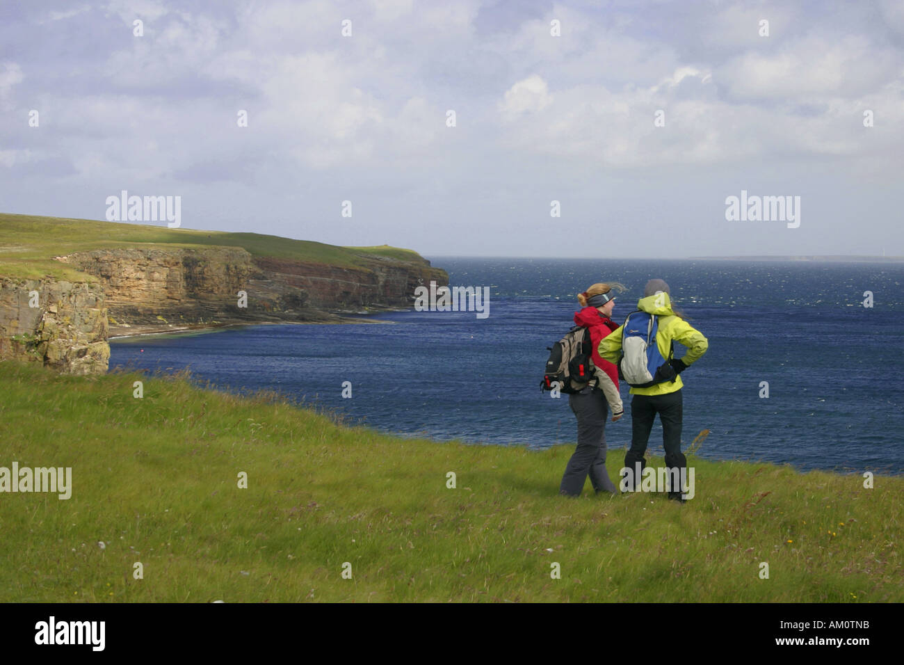Two young women walking at Mull Head RSPB Reserve, Orkney Stock Photo