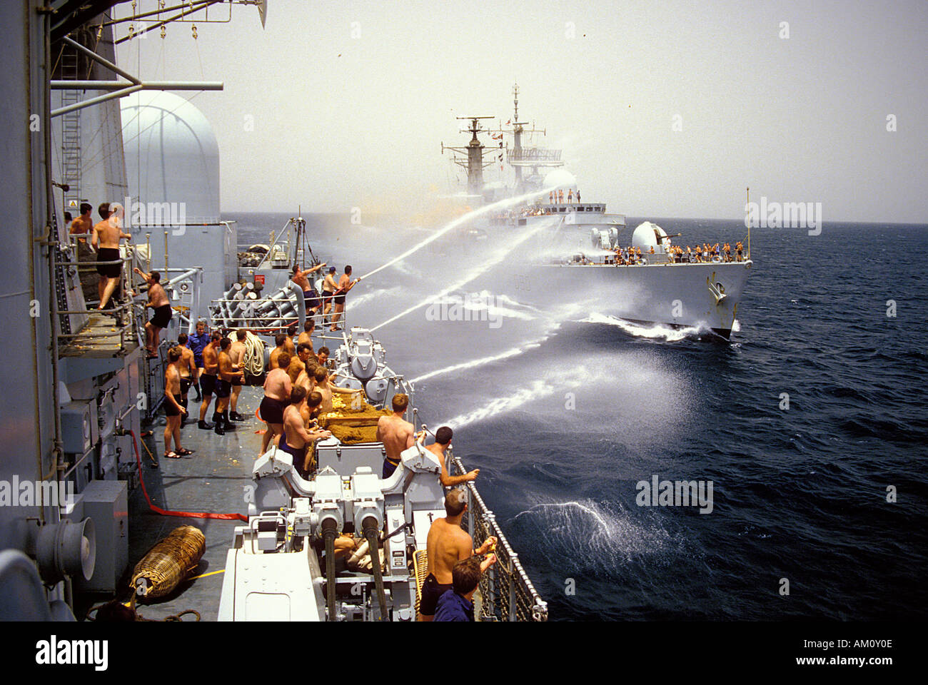 HMS York about to exchange potatoes and eggs with HMS Southampton as she departs the Armilla patrol for the UK during the Iraq Iran War, 1986 Stock Photo