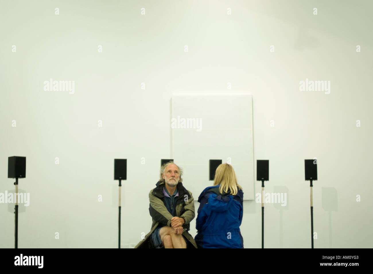 man and woman listening to Janet Cardiff s sound audio sculpture installation 'Forty-Part Motet'  Aberystwyth Arts Centre Wales Stock Photo