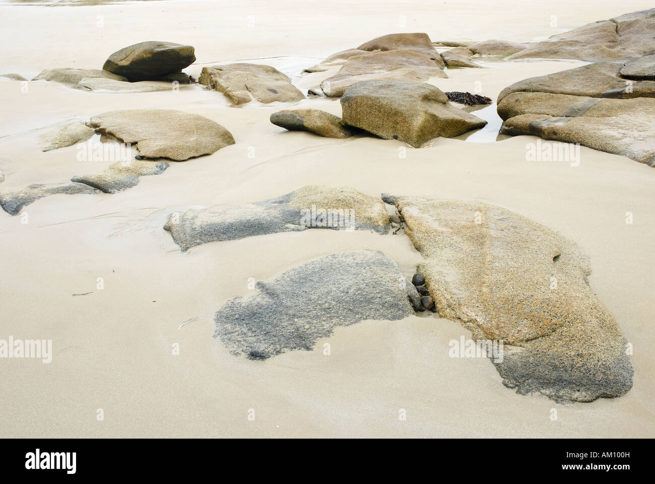 Granite rocks in tidal zone of sandy beach at the Altanic coast of Donegal, Ireland Stock Photo