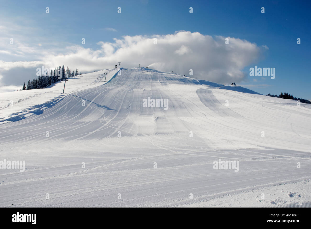 Skiing slope with snow machine in action, Austria Stock Photo
