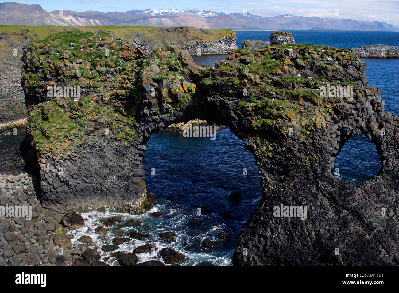 Basalt rock arch at the volcanic cliff coast of Arnarstapi in Iceland - Arnarstapi, Snaefellsnes-peninsula, Iceland, Europe Stock Photo