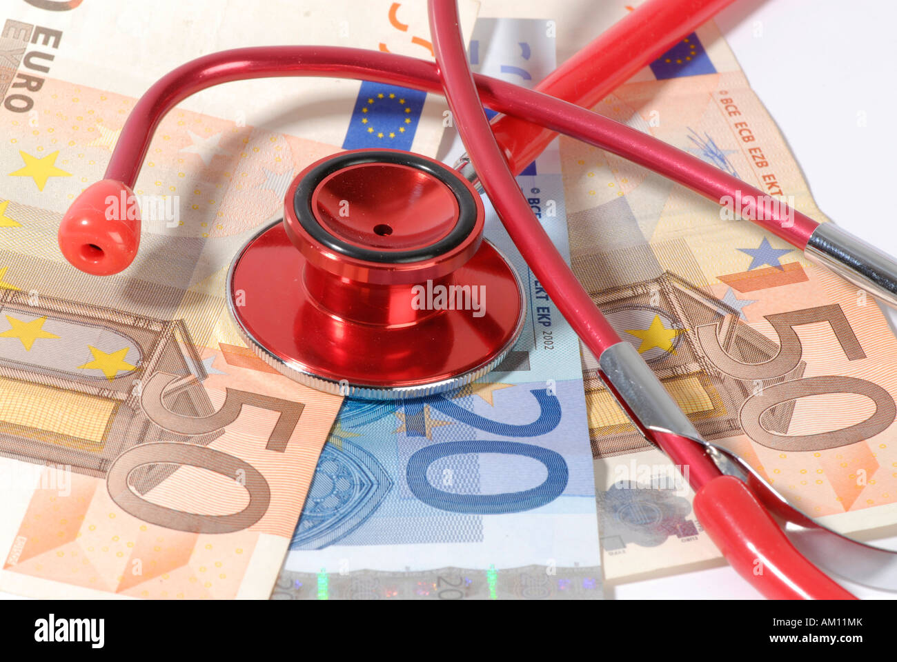 Banknotes and stethoscope Stock Photo