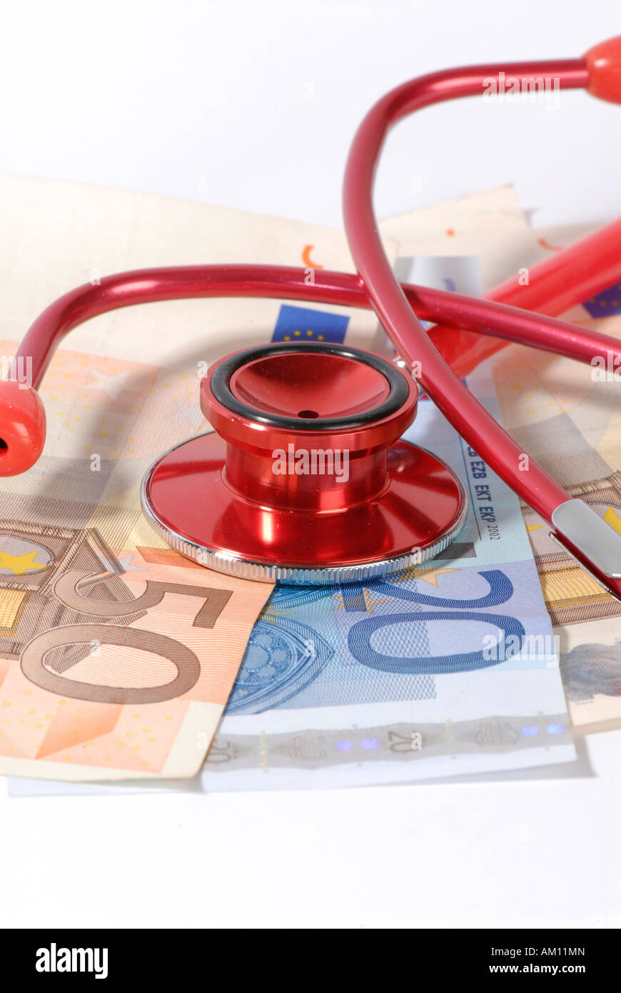 Banknotes and stethoscope Stock Photo