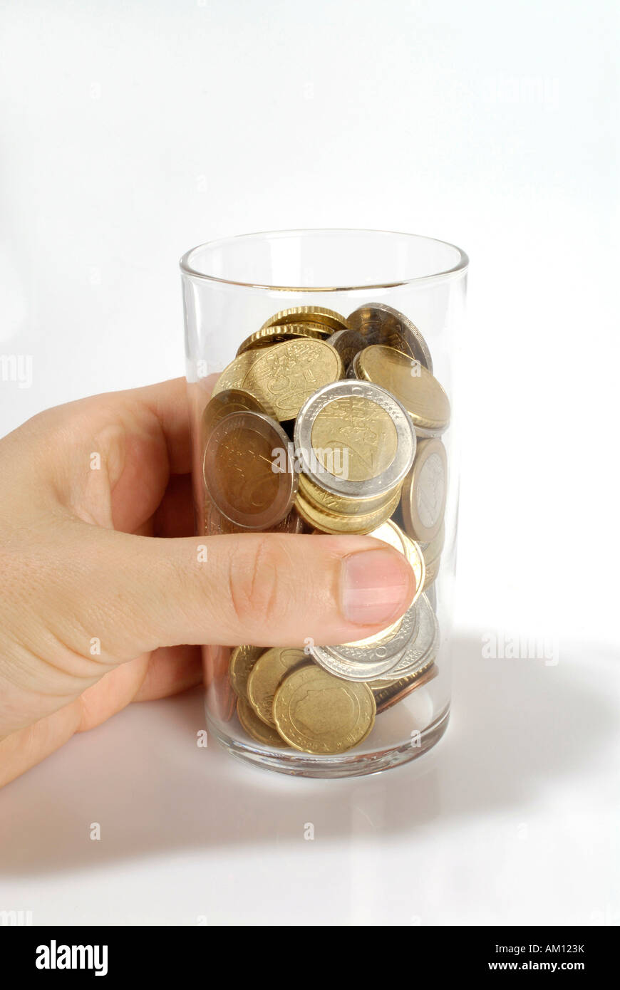Tip - hand holding a glass with Euro coins Stock Photo
