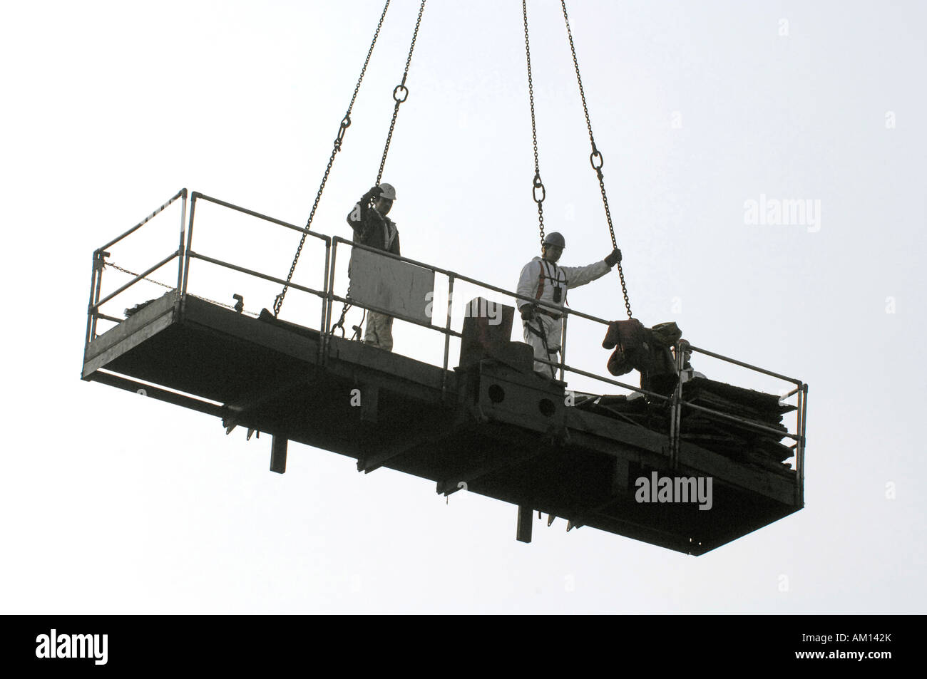 Stripping down - Workers on a platform hanging on a crane. Closed down steel mill. Maxhuette. Sulzbach-Rosenberg, Bavaria, Germ Stock Photo