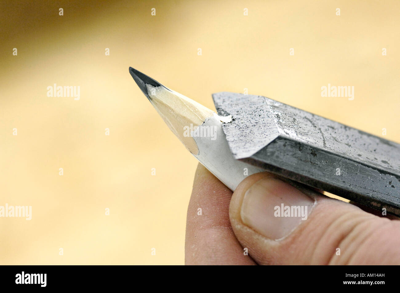 Sharpening a pen with a chisel, Carpentering Stock Photo