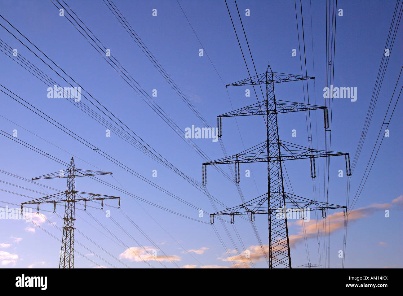 Power poles high voltage electrical power lines sunrise at winter