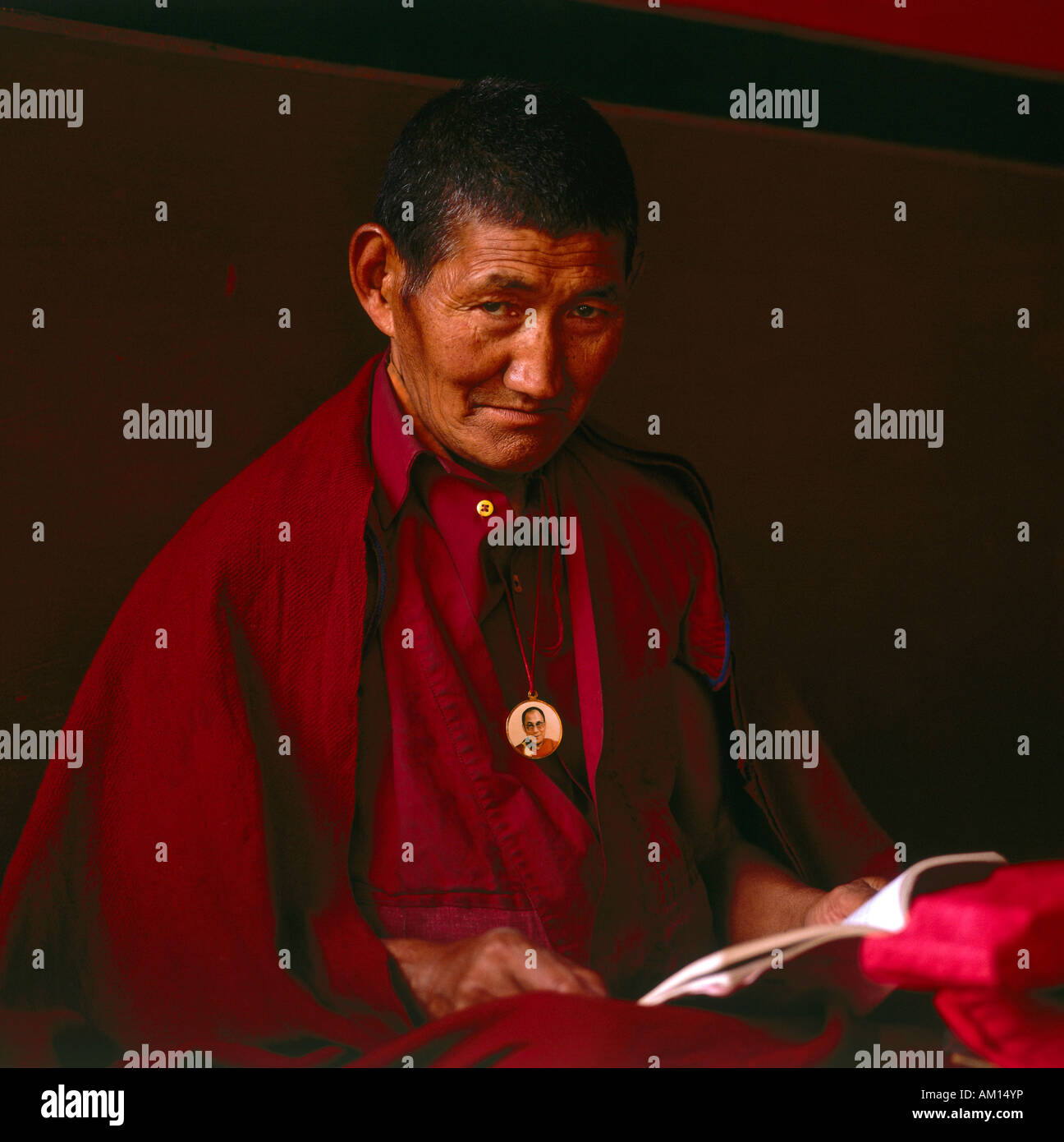 Tibetan monk with amulet of the Dalai Lama, India Stock Photo - Alamy