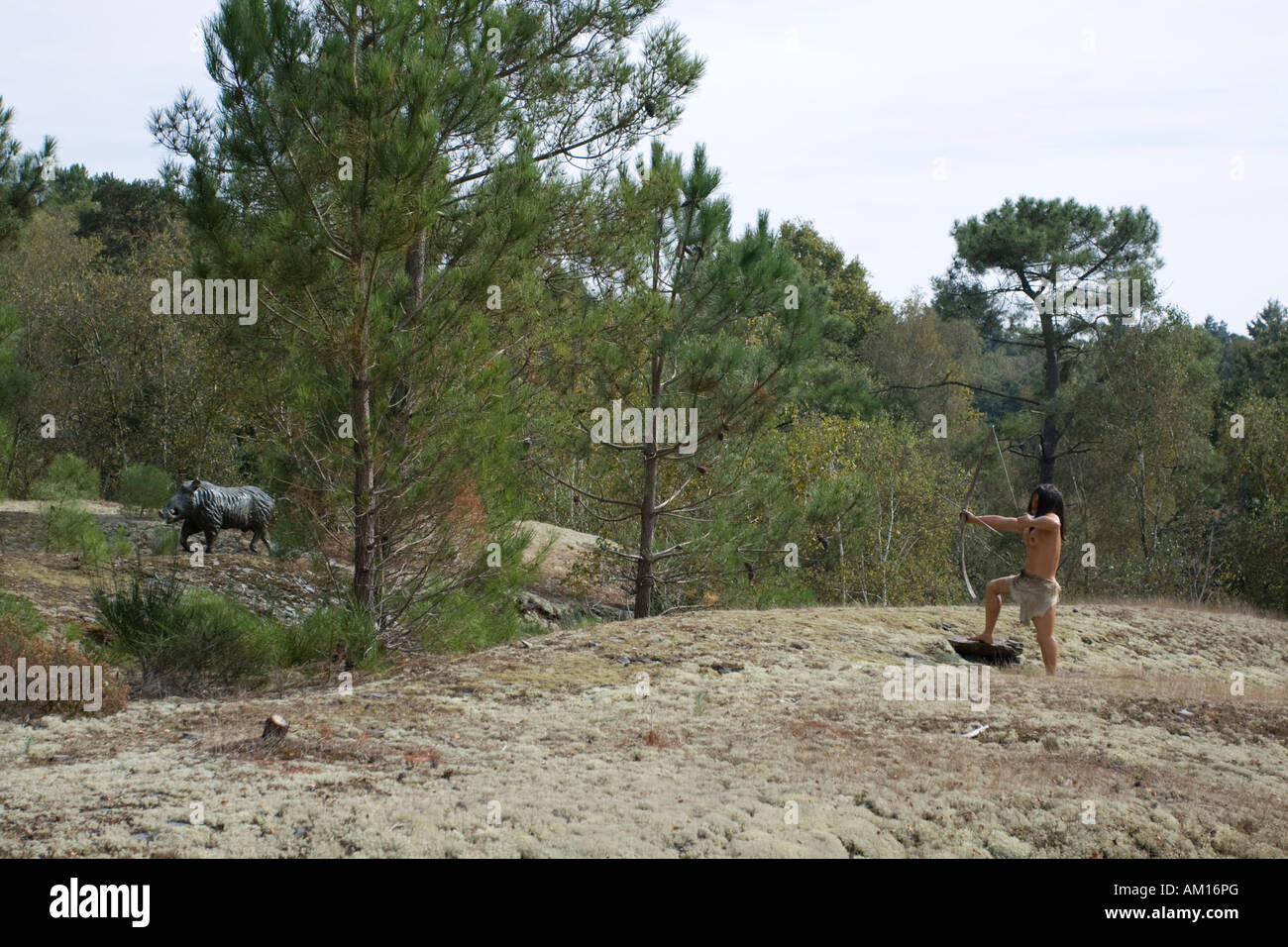 Mesolithic man hunting wild boar with bow and arrow life size models