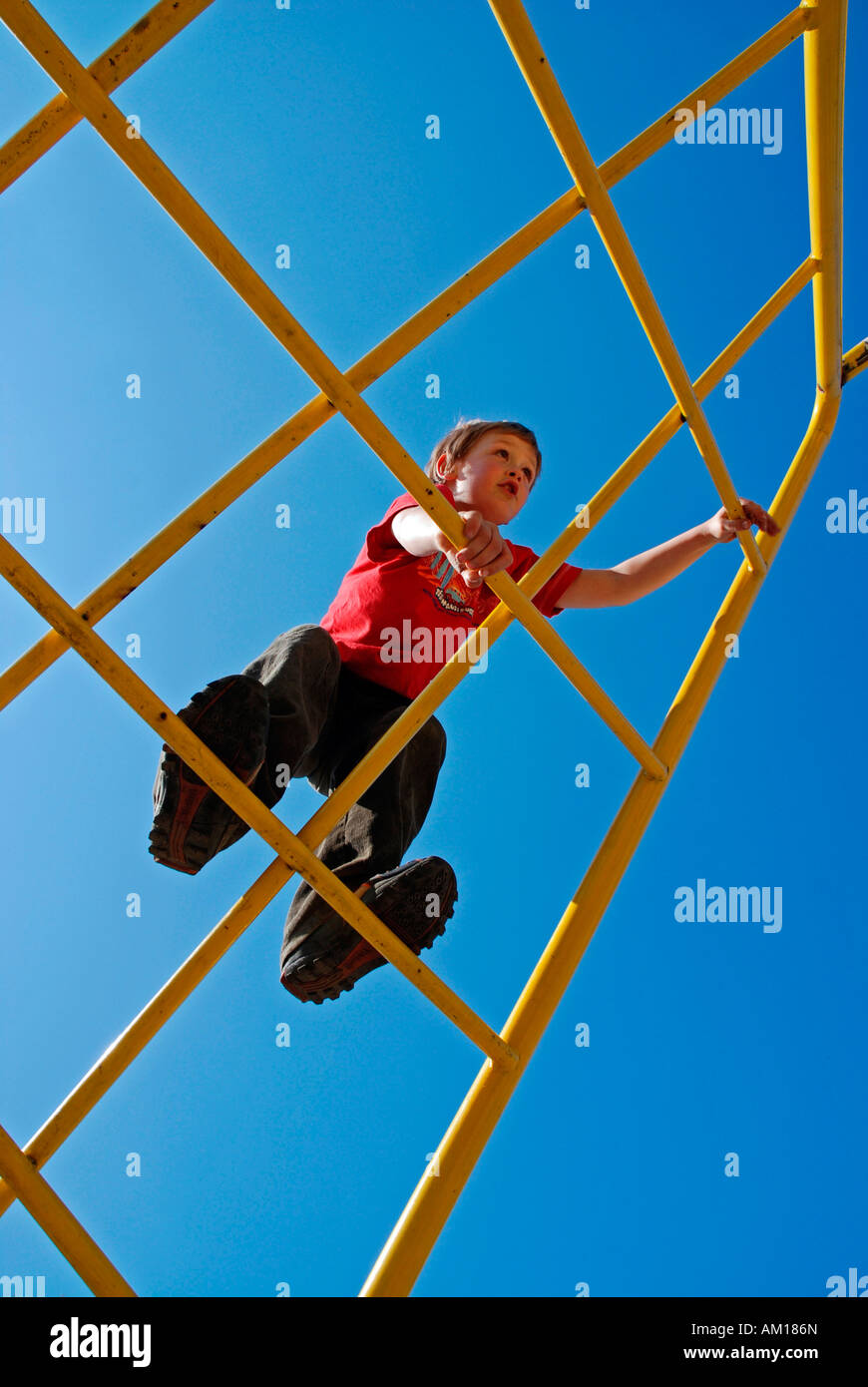 Boy, 7 years old, climbing on a jungle gym, Cologne, North Rhine-Westphalia, Germany Stock Photo