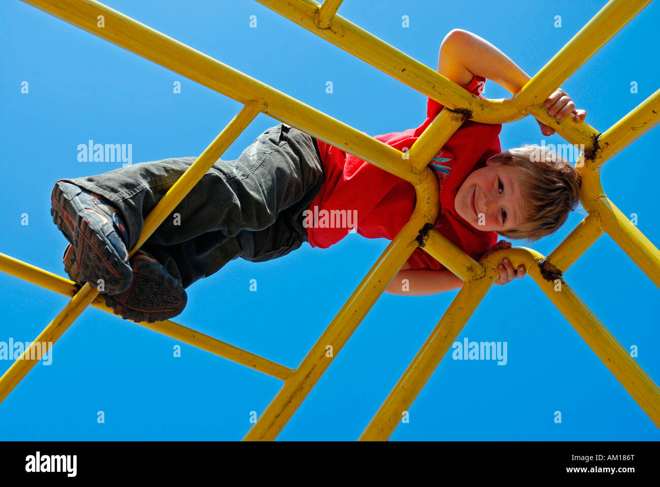 Boy, 7 years old, climbing on a jungle gym, Cologne, North Rhine