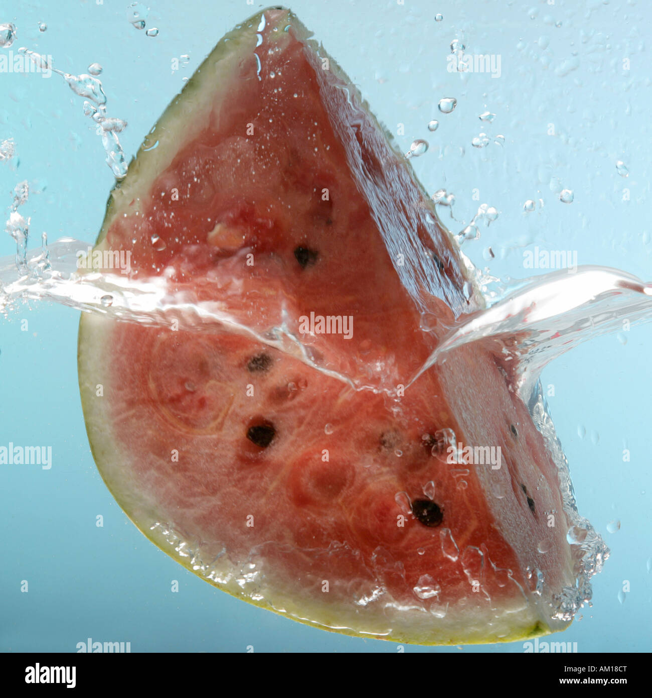 Watermelon falling into water Stock Photo