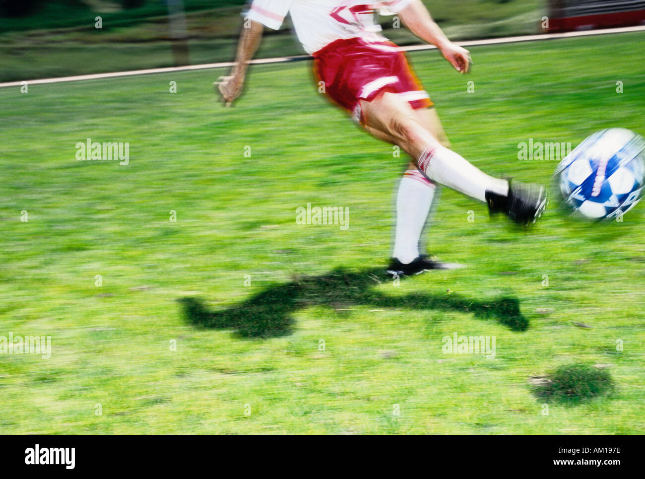 A football soccer player kicking the ball Stock Photo