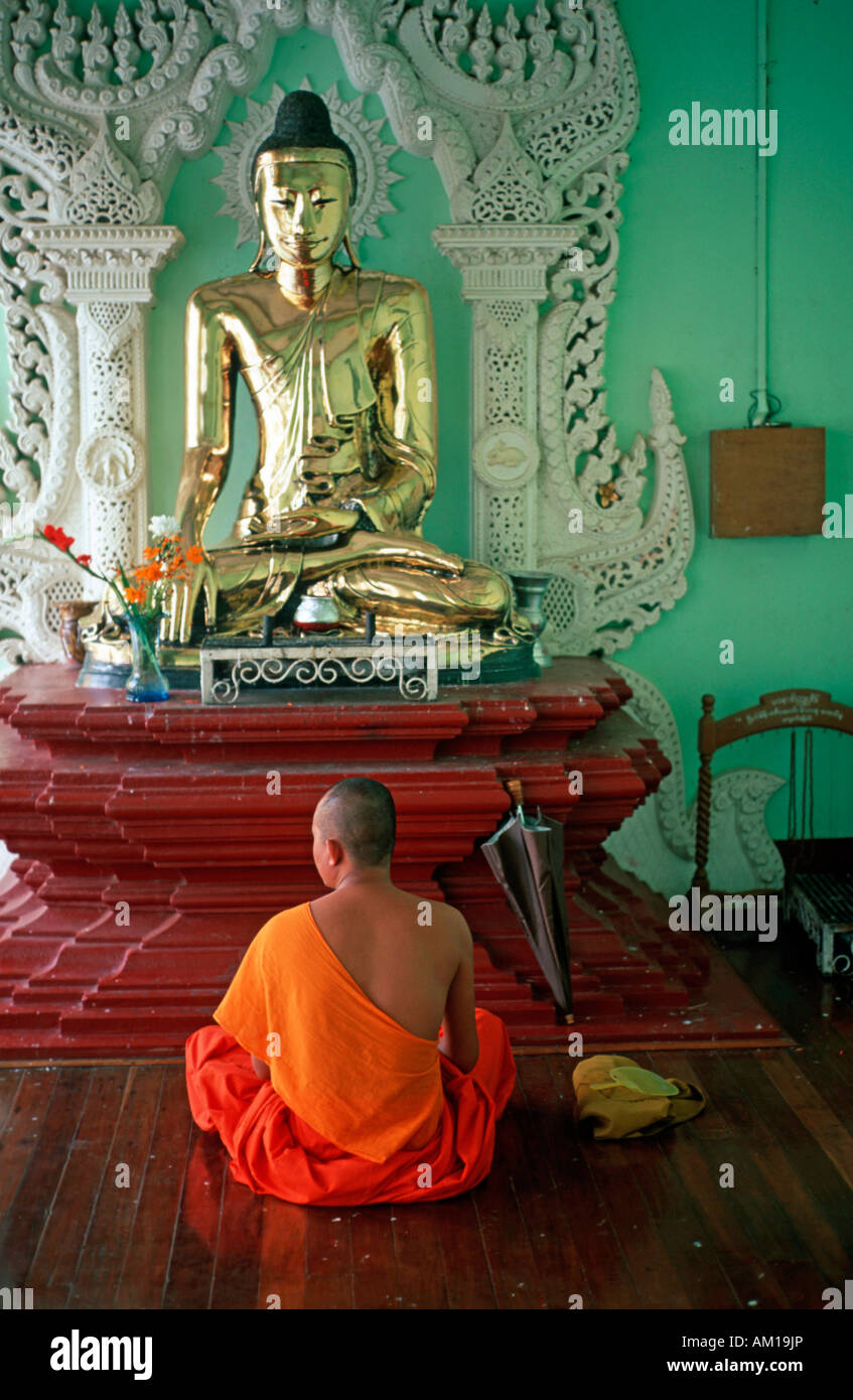 Meditation in front of a Buddha statue, Yangon, Burma, Asia Stock Photo
