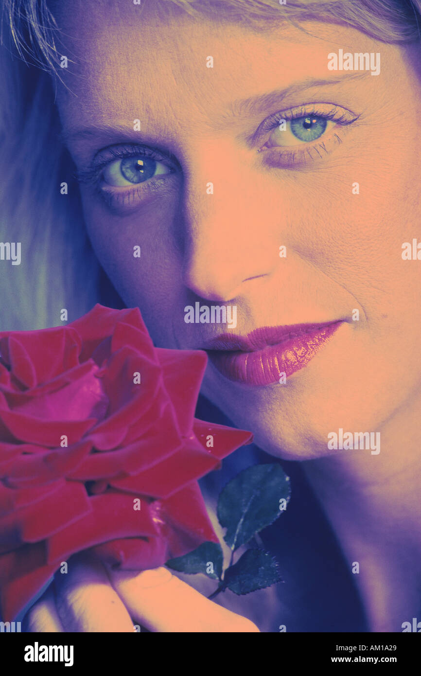 Woman with red rose and lips and blue eyes Stock Photo - Alamy