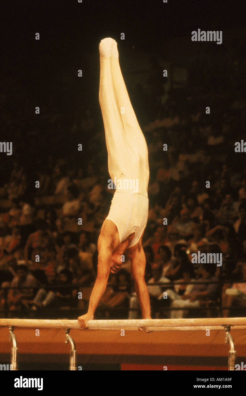 Male gymnast performing on parallel bars during Olympics in Los Angeles Stock Photo
