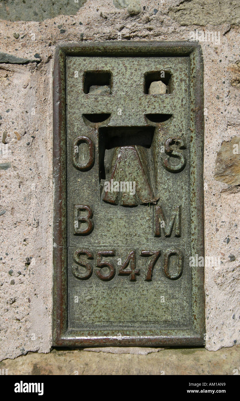 Plaque on triangulation pillar (trig point) on the summit of Loughrigg in the English Lake District. Stock Photo