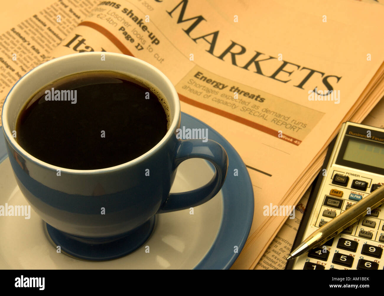Cup of coffee business newspaper and calculator,  financial investment concept Stock Photo