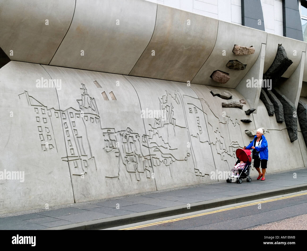 A woman and child passing by the Canongate wall Scottish Parliament Edinburgh Stock Photo