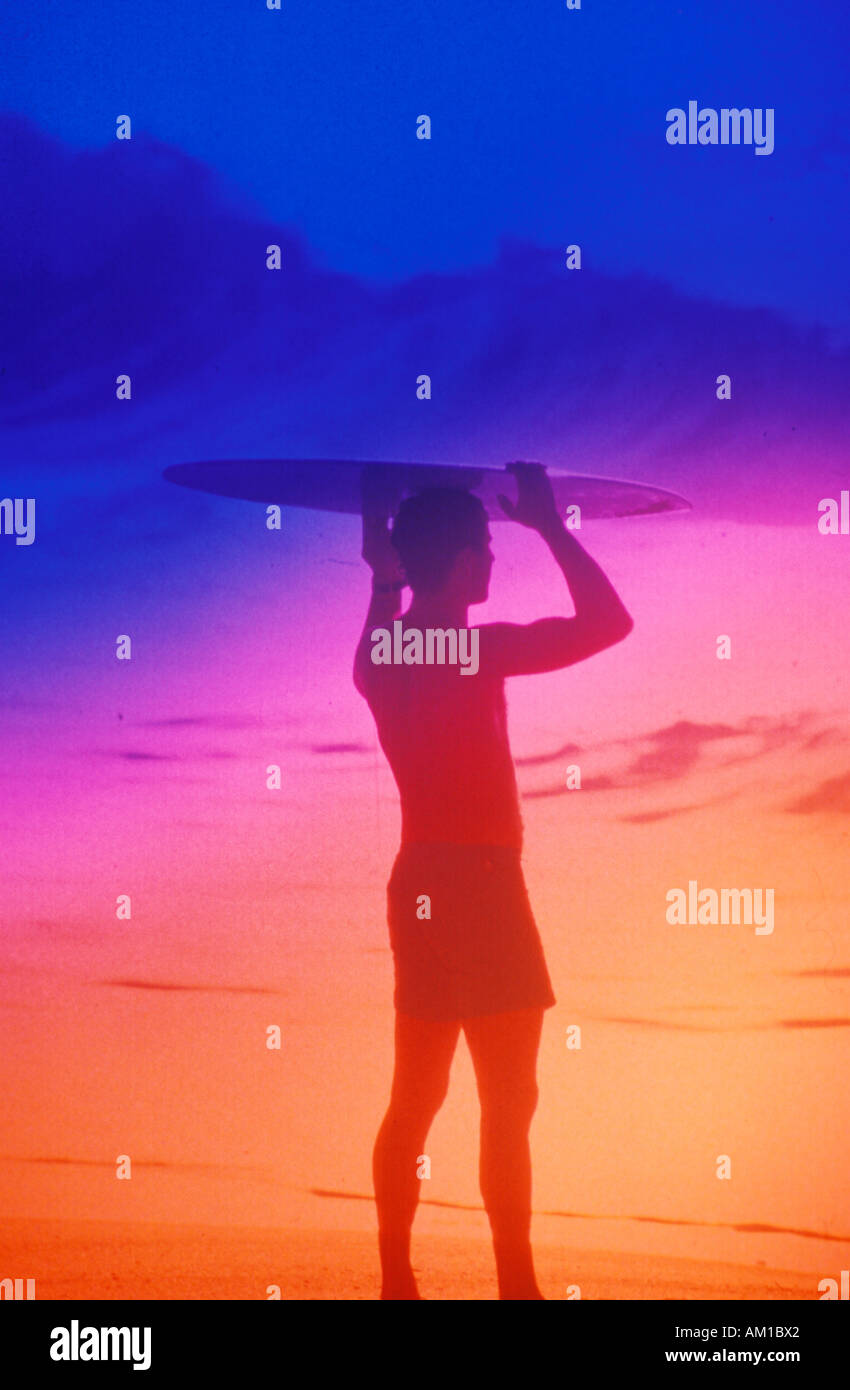 Silhouette of surfer with board on head Stock Photo